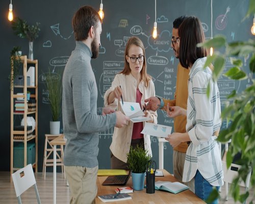 Group of colleagues discussing lifestyle project in a modern office
